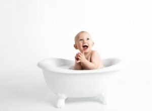 image of Baby Inside White Bathtub With Water